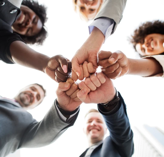 Fotografia de um time feliz e reunido. Todos estão conectados para bem da empresa.